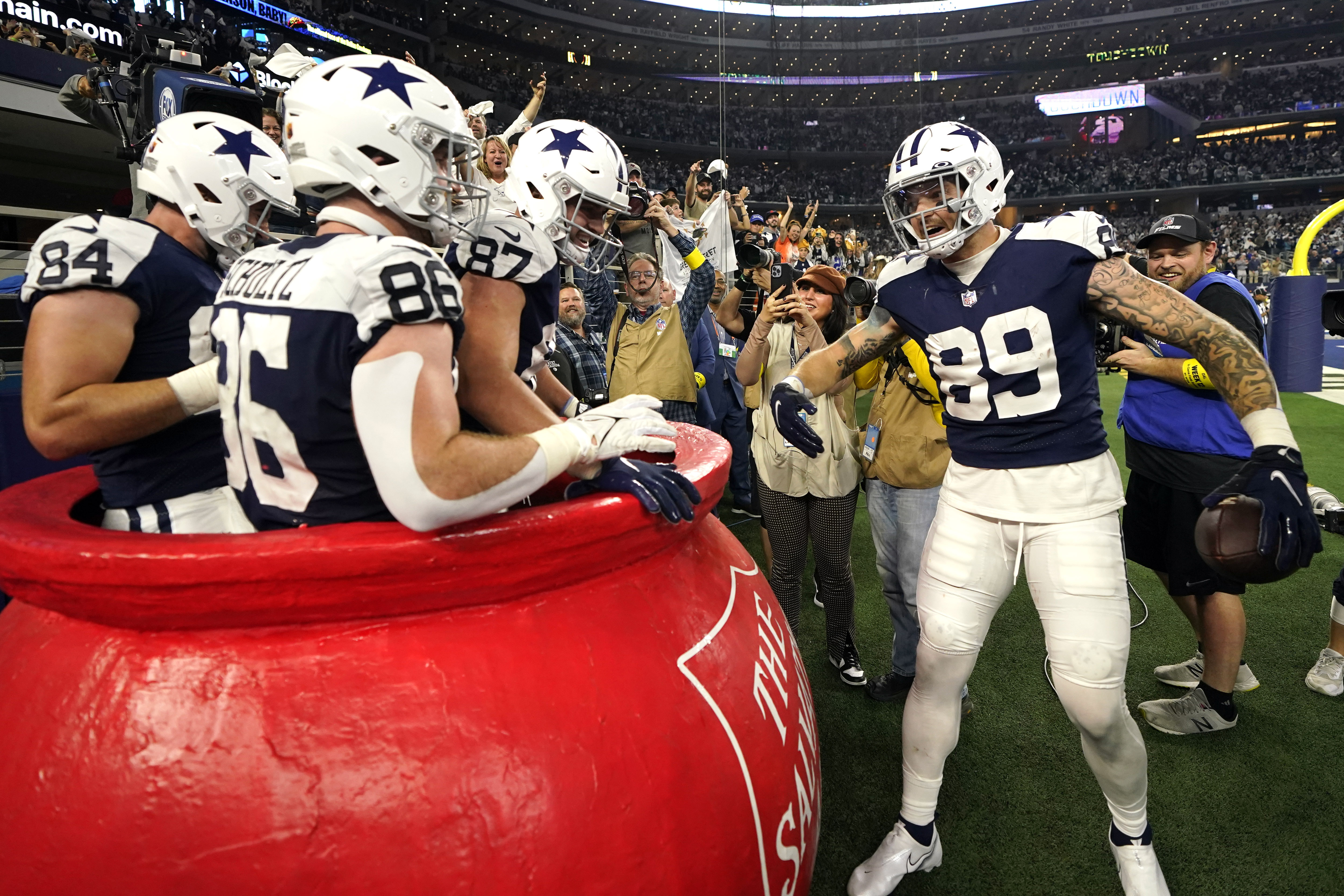 Cowboys TEs celebrate 4th-quarter touchdown with whack-a-mole in Salvation  Army kettle