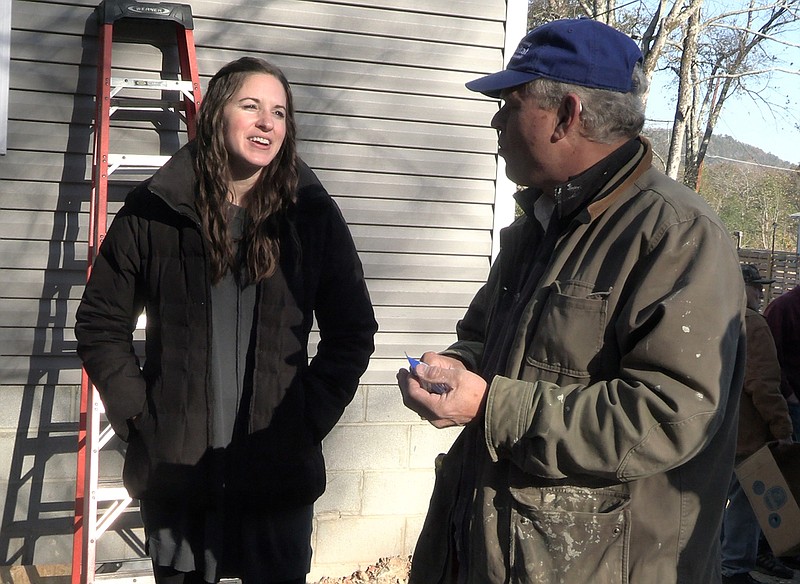 Libby Harrington, left, speaks with a volunteer at the construction site of a Habitat for Humanity home. – Photo by Courtney Edwards of The Sentinel-Record