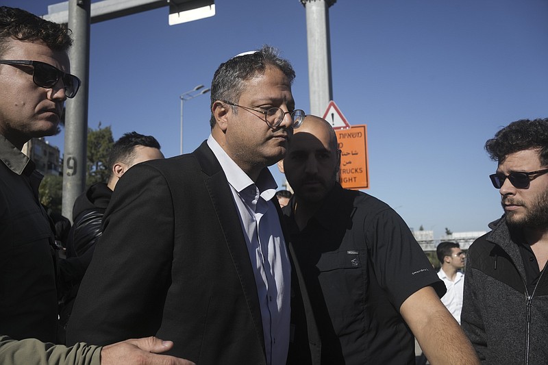 Israeli far-right lawmaker Itamar Ben-Gvir arrives at the scene of an explosion at a bus stop in Jerusalem, Wednesday, Nov. 23, 2022. Two blasts went off near bus stops in Jerusalem on Wednesday, injuring a dozen of people in what police said were suspected attacks by Palestinians. (AP Photo/Maya Alleruzzo)