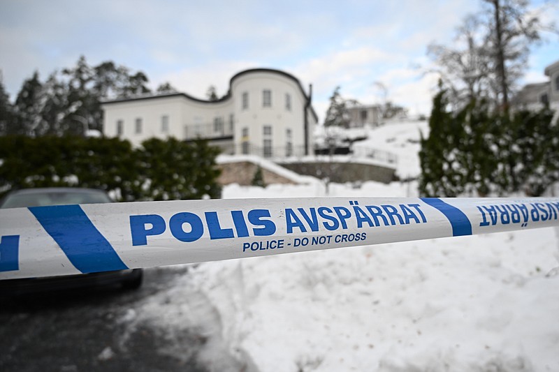 A police tape cordons an area outside a house where Swedish Security Service allegedly arrested two people on suspicions of espionage in a predawn operation in Stockholm, Tuesday, Nov. 22 2022. The authorities gave few details about the case, but Swedish media cited witnesses who described elite police rappelling from two Black Hawk helicopters to arrest a couple that had allegedly spied for Russia. (Fredrik Sandberg/TT News Agency via AP)