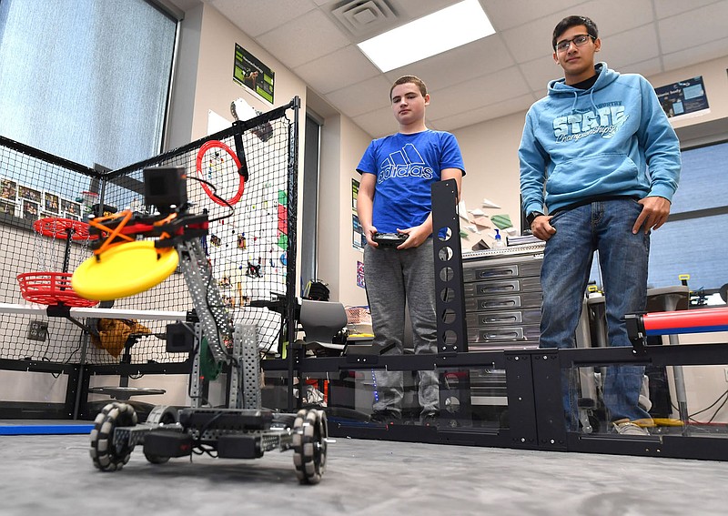 Evan Laird (left) and Ryan Layes, both students at Elkins High School, operate a VEX robot Friday, Nov. 18, 2022, while working at school in Elkins. School enrollment region-wide is up 1.8%, but some school districts Ã‘ like Elkins, at 6.1% Ã‘ are seeing significantly more growth than others. Visit nwaonline.com/221120Daily/ for today's photo gallery. 
(NWA Democrat-Gazette/Andy Shupe)