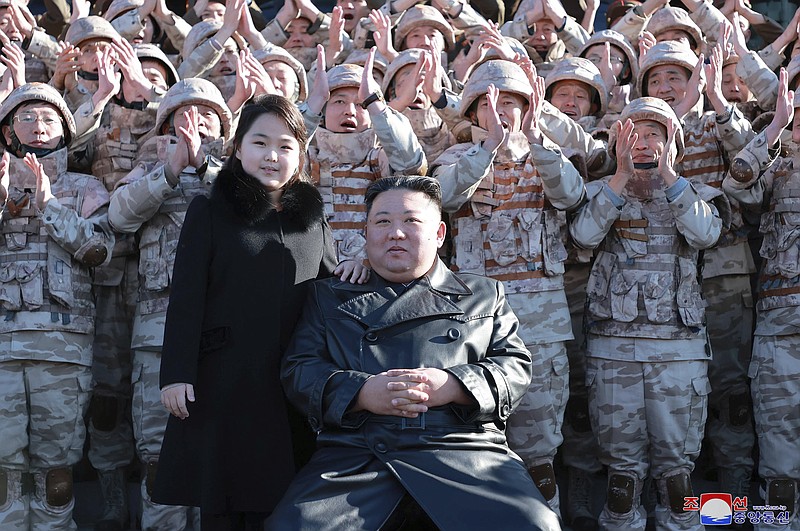 This undated photo provided on Nov. 27, 2022, by the North Korean government shows North Korean leader Kim Jong Un, center right, and his daughter, center left, with soldiers, pose for a photo,  following the launch of what it says a Hwasong-17 intercontinental ballistic missile, at an unidentified location in North Korea. Independent journalists were not given access to cover the event depicted in this image distributed by the North Korean government. The content of this image is as provided and cannot be independently verified. Korean language watermark on image as provided by source reads: &quot;KCNA&quot; which is the abbreviation for Korean Central News Agency. (Korean Central News Agency/Korea News Service via AP)