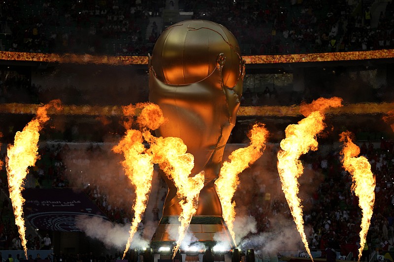 An inflatable depicting the World Cup trophy is seen during pregame celebrations prior to the World Cup group F soccer match between Belgium and Morocco, at the Al Thumama Stadium in Doha, Qatar, Sunday, Nov. 27, 2022. (AP Photo/Frank Augstein)