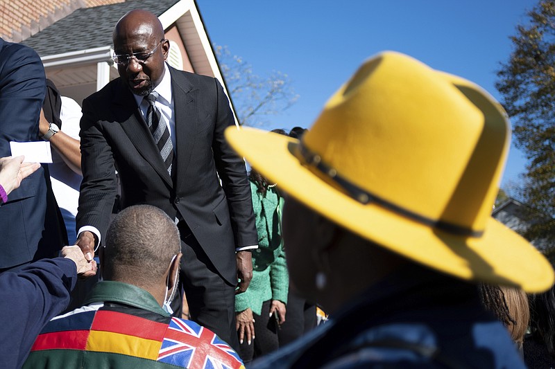 Sen. Raphael Warnock, D-Ga., shakes hands at a rally before walking to cast his early vote Sunday, Nov. 27, 2022, in Atlanta, in his runoff election against Republican Herschel Walker. (AP Photo/Ben Gray)