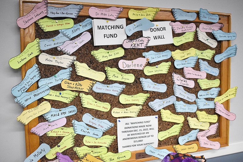 Democrat photo/Garrett Fuller — A bulletin board seen Nov. 18 features "feet" with the names of many donors at the California Nutrition Center.