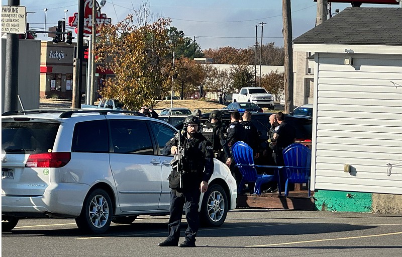 Hot Springs police are shown after a suspect in a threatening incident Monday morning was taken into custody after a standoff that followed a traffic stop in the 1300 block of Albert Pike Road. - Photo by Mark Gregory of The Sentinel-Record