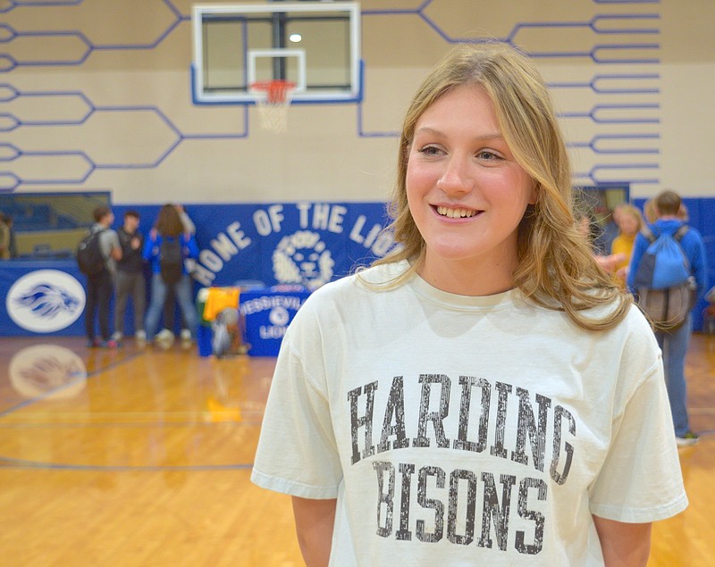 Jessievillie Senior cross-country and track runner Juliah Rodgers signs her letter of intent to run cross-country for the Harding Bisons Monday. - Photo by Donald Cross of The Sentinel-Record