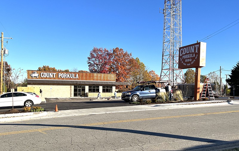 Workmen finish the landscaping and the parking lot at the Count Porkula at 201 Keightley Drive. The barbecue restaurant moved out of its space at the Rail Yard and into the new building this week; opening day is yet to be determined. (Arkansas Democrat-Gazette/Eric E. Harrison)