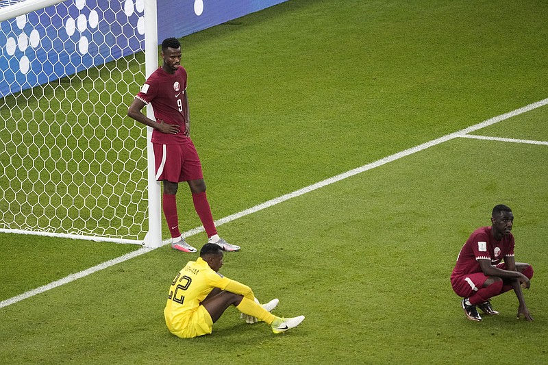 Qatar's Mohammed Muntari, left, and Qatar's goalkeeper Meshaal Barsham look on after the World Cup group A soccer match between Qatar and Senegal, at the Al Thumama Stadium in Doha, Qatar, Friday. Senegal won 3-1. Qatar became the first host nation in World Cup history to lose the opening match, and then only the second host to be eliminated from the group stage. - Photo by Ariel Schalit of The Associated Press
