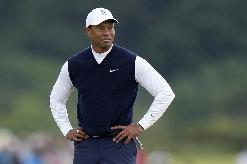 Tiger Woods, of the United States, stands on the 11th hole during the first round of the British Open golf championship on the Old Course at St. Andrews, Scotland, on July 14. Woods was out before he was officially back, withdrawing Monday, from his Hero World Challenge with plantar fasciitis in his right foot. - Photo by Alastair Grant of The Associated Press