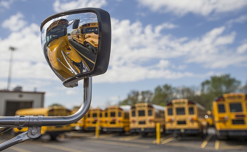 School busses park Thursday, April 16, 2020, at the Bentonville School District's bus barn in Bentonville. 
(NWA Democrat-Gazette/Ben Goff)