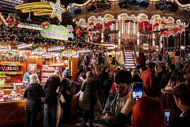 A festive confectionery stall and traditional carousel at the Roemer Square Christmas Market in Frankfurt, Germany, on Nov. 24, 2022. MUST CREDIT: Bloomberg photo by Ben Kilb.