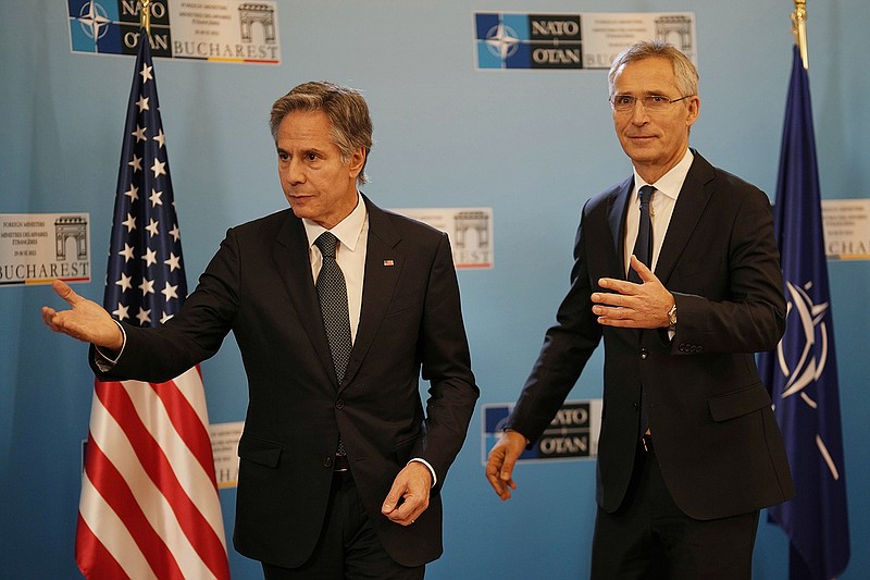 U.S. Secretary of State Antony Blinken, left, gestures with NATO Secretary-General Jens Stoltenberg in Bucharest, Romania, Tuesday, Nov. 29, 2022. Blinken attends the meeting of NATO Ministers of Foreign Affairs in the Romanian capital. (AP Photo/Vadim Ghirda, Pool)