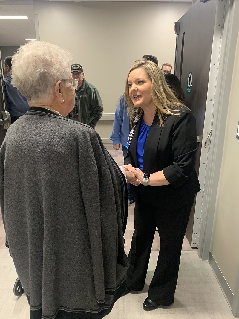 Sevier County Medical Center CEO Lori House visits with a county resident Friday, Dec. 2, 2022, at the hospital’s grand opening in De Queen, Ark. Sevier County voters approved a 1% sale tax in a 2019 special election to build the hospital. The former hospital, which was owned by an out-of-state company, closed earlier in 2019 after a series of financial setbacks. (Staff photo by Lori Dunn)
