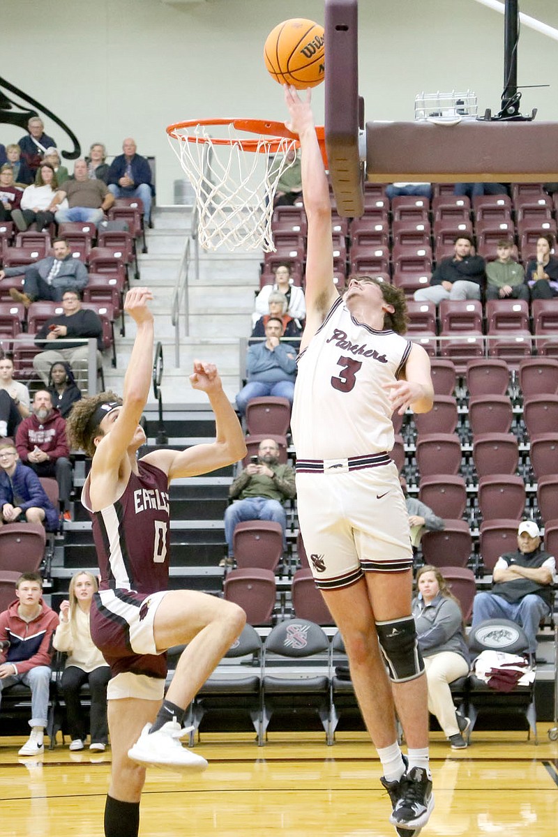Mark Ross/Special to the Herald-Leader
Siloam Springs senior Nathan Vachon (right) goes up for a reverse layup as Huntsville's Kayden McCubbin defends on the play on Friday, Dec. 2, at Panther Activity Center. Siloam Springs rallied from a 10-point deficit in the fourth quarter to defeat the Eagles 55-43.