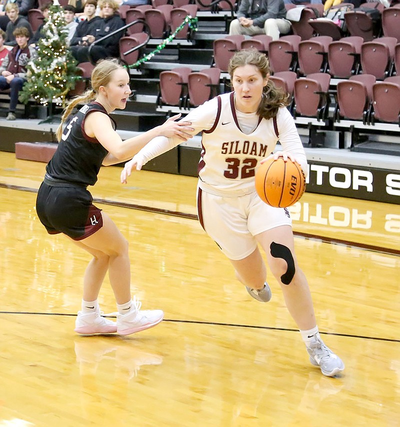 Mark Ross/Special to the Herald-Leader
Siloam Springs senior Brooke Smith drives to the basket as Huntsville's Mena Thomas defends on the play Friday, Dec. 2, at Panther Activity Center. Siloam Springs defeated Huntsville 57-22.