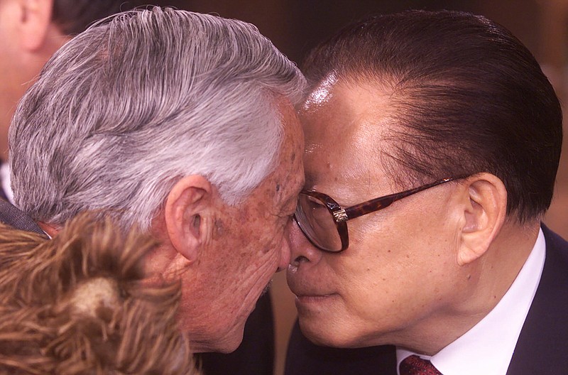 FILE - Chinese President Jiang Zemin, right, does the "Hongi", a traditional greeting of nose touching, with Maori Elder Hugh Kawharu at a welcoming ceremony for Asia Pacific Economic summit, APEC leaders in Auckland, New Zealand, Sept. 12, 1999. Chinese state TV said Wednesday, Nov. 30, 2022, that Jiang has died at age 96. (AP Photo/David Guttenfelder, File)