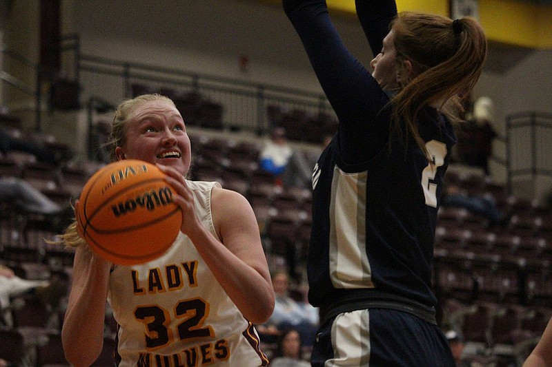 Lake Hamilton's Nancy Coffman (32) works under the basket while Greenwood's Madison Cartwright (2) defends Nov. 17 at Wolf Arena. - Photo by Krishnan Collins of The Sentinel-Record