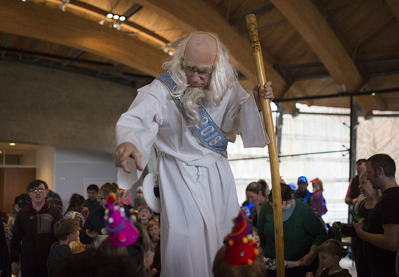 Father Time greets kids during a previous Noon Year’s Eve event at Crystal Bridges Museum of American Art in Bentonville. The event offers art making, live music and performances, games, dancing, glamorous activities inspired by "Fashioning America: Grit to Glamour," and a Coca-Cola New Year’s toast at noon.
(NWA Democrat-Gazette File Photo/Charlie Kaijo)