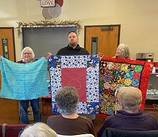 The Pieces N Patches quilt club recently presented the Pea Ridge Police Department 25 quilts for kids. The quilts will be used to bring comfort to children during difficult situations. Pictured are Project Chairs Cathy Drexler and Ellen Whitlow with Pea Ridge Lt. Rich Fordham.

(Courtesy Photo)