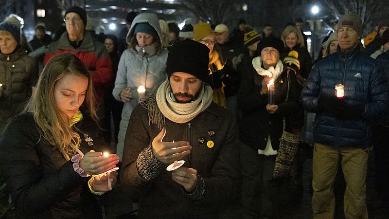 People attend a vigil at the University of Idaho Boise Campus on Wednesday, Nov. 30, 2022, in downtown Boise, Idaho, to honor the four students killed earlier this month in Moscow, Idaho.  (Darin Oswald/Idaho Statesman via AP)