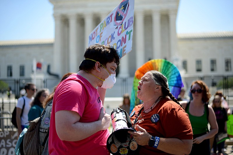 An abortion rights activist, left, argues with an anti-abortion activist in June 2022 outside the U.S. Supreme Court. (Photo for The Washington Post by Astrid Riecken)