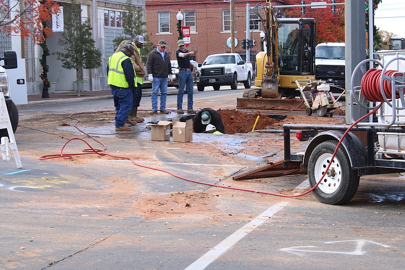 El Dorado Water Utilities workers discuss water main repairs on Main Street early Thursday afternoon. (Caitlan Butler/News-Times)