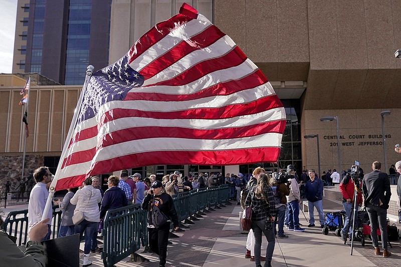 People wait to enter the Maricopa County Board of Supervisors auditorium prior to the board's general election canvass meeting, Monday, Nov. 28, 2022, in Phoenix. (AP Photo/Matt York)