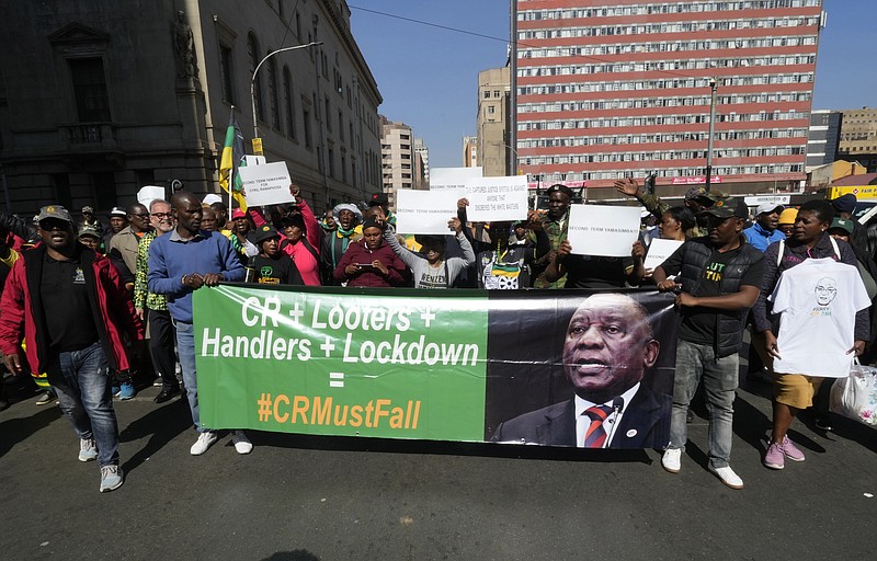 FILE — African National Congress (ANC) members protest outside the party's headquarters at Luthuli House in Johannesburg, South Africa, Friday, July 15, 2022, to demand action be taken against President Cyril Ramaphosa over his Phala Phala farm saga. Ramaphosa is facing serious calls to step down after a parliamentary probe found he may have breached the country's anti-corruption laws related to the theft of millions of dollars at his Phala Phala game farm.(AP Photo/Themba Hadebe/File)
