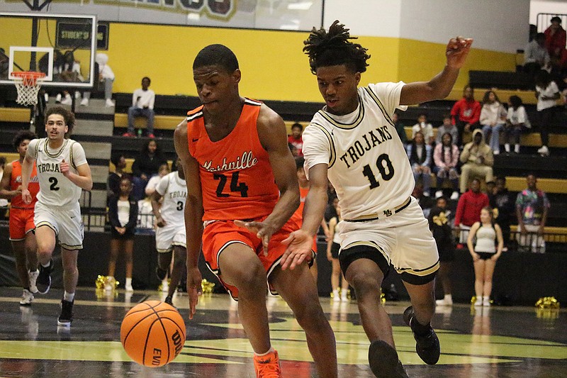 Hot Springs' Derrick Hicks (10) chases after Nashville's Tayshaun Davis (24) during the Hot Springs Invitational Thursday at Trojan Arena. - Photo by Krishnan Collins of The Sentinel-Record