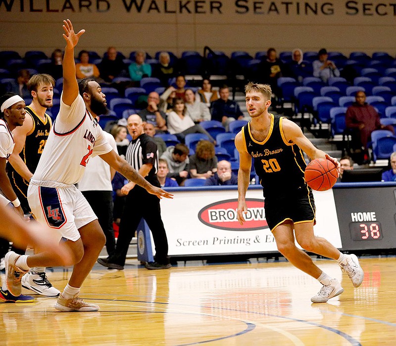 Photo courtesy of JBU Sports Information
John Brown guard Malachi Reeves handles the ball outside the 3-point line against Langston on Saturday, Dec. 3, at Bill George Arena.