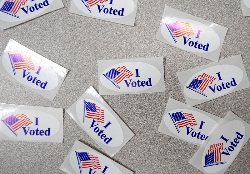 Stickers await voters June 14 at the Washington County Courthouse in Fayetteville.  
(File Photo/NWA Democrat-Gazette/J.T. Wampler)
