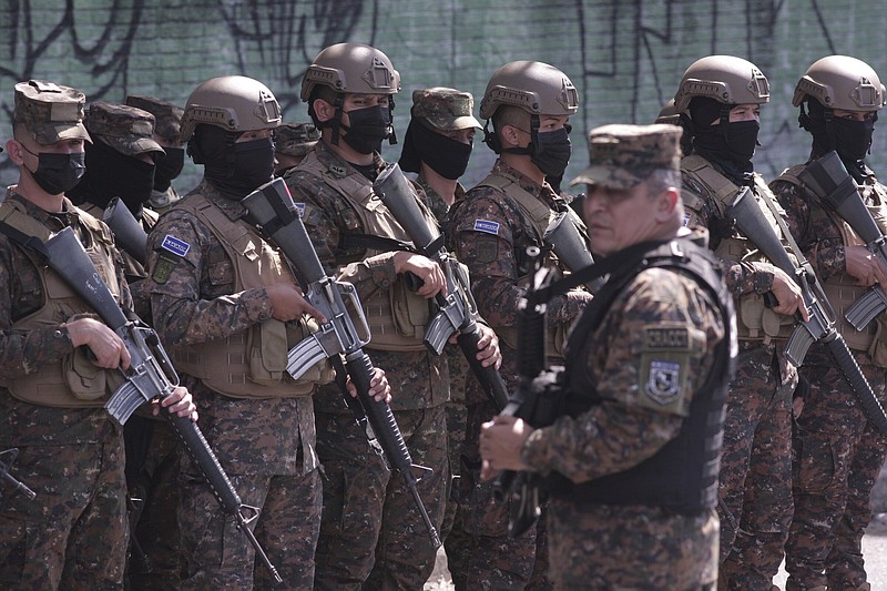 Soldiers arrive in Soyapango, El Salvador, Saturday, Dec. 3, 2022. The government of El Salvador sent 10,000 soldiers and police to seal off Soyapango, on the outskirts of the nation's capital Saturday to search for gang members. (AP Photo/Salvador Melendez)