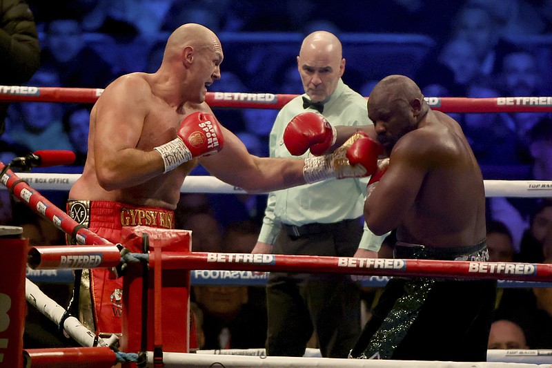 Tyson Fury, left, lands a punch during his WBC heavyweight championship boxing match against Derek Chisora at Tottenham Hotspur's White Hart Lane stadium London, Saturday Dec. 3, 2022.(AP Photo/Ian Walton)