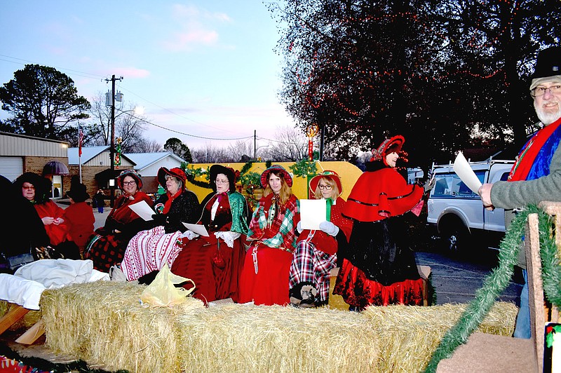 MARK HUMPHREY ENTERPRISE-LEADER/The congregation of Lincoln First Assembly of God Church dressed as traditional Christmas carolers and sang while riding a float in the Lincoln Christmas parade on Saturday, Dec. 3, 2022. The float won first place in the parade.