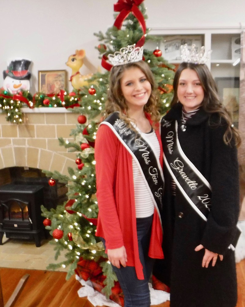 Westside Eagle Observer/SUSAN HOLLAND Brooklyn Parker, Miss Gravette Preteen 2022, and Keeli Moore, Miss Gravette 2022, pause for a photograph at the Gravette Community Building Saturday evening. Both young ladies rode in the annual Christmas parade and were on hand afterward at the chili cookoff and at the community building to visit with guests enjoying the evening.