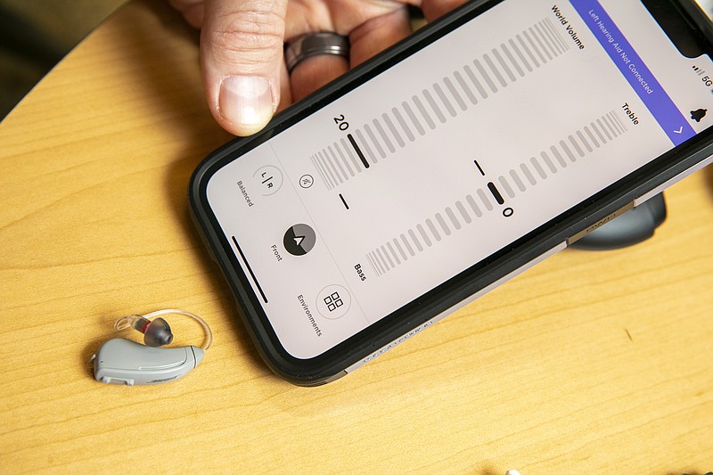 Sterling Sheffield, an assistant professor of Speech, Language, and Hearing Sciences at the University of Florida, shows an iPhone app that controls a Bose hearing aid Wednesday, Nov. 30, 2022, in Gainesville, Fla. OTC hearing aids started hitting the market in October after the FDA approved them for adults with mild-to-moderate hearing loss, and Sheffield has been testing them. (AP Photo/Alan Youngblood)