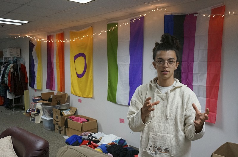 Sean Fisher, one of the student coordinators for QPLUS, the LGBTQ student organization for the College of Saint Benedict and Saint John's University, stands in the organization's dedicated lounge on the college's campus Tuesday, Nov. 8, 2022, in St. Joseph, Minn. To Fisher, a senior in environmental studies who identifies as nonbinary, the Catholic colleges' recognition and funding of the organization represents a new era. (AP Photo/Giovanna Dell'Orto)