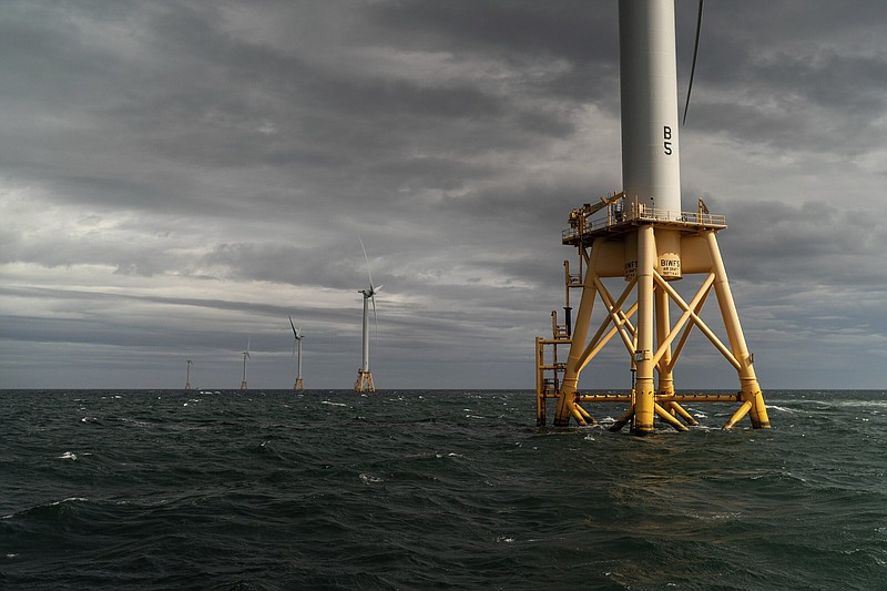 FILE - The five turbines of America's first offshore wind farm, owned by the Danish company, Orsted, stand off the coast of Block Island, R.I., in this, Oct. 17, 2022. The wind farm allowed residents of small Block Island to shut off five diesel generators. Tuesday, Dec. 6, marks the first-ever U.S. auction for leases to develop commercial-scale floating wind farms in the deep waters off the West Coast. (AP Photo/David Goldman, File)