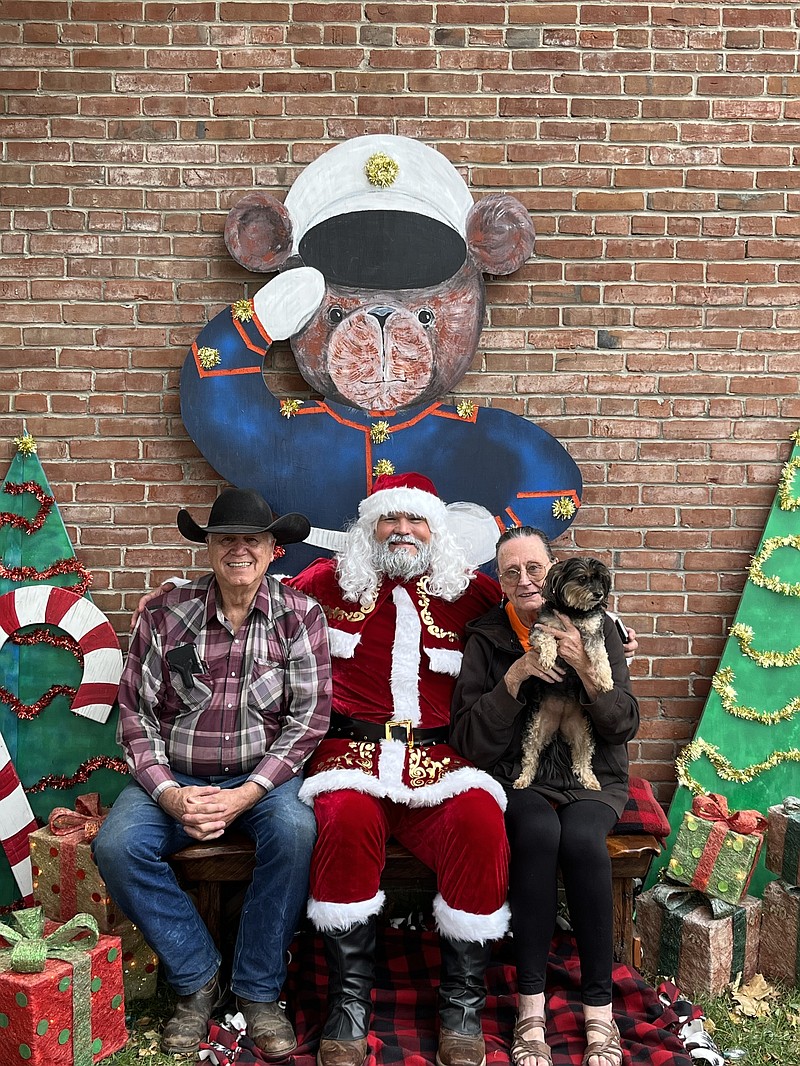 Submitted photo: 
Moniteau County Toys for Tots program coordinator Kris Ingram, middle, poses with former coordinator Dan Mesey and his wife Carol for a photo as Santa Claus.