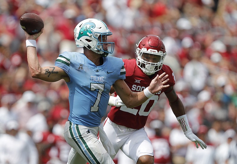 Tulane quarterback Michael Pratt throws a pass as Oklahoma linebacker Clayton Smith, of Texarkana, Texas, closes in Saturday, Sept. 4, 2021, in Norman, Okla. (AP Photo/Alonzo Adams)