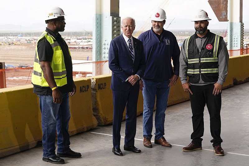 President Joe Biden tours the building site for a new computer chip plant for Taiwan Semiconductor Manufacturing Company, Tuesday, Dec. 6, 2022, in Phoenix. (AP Photo/Patrick Semansky)