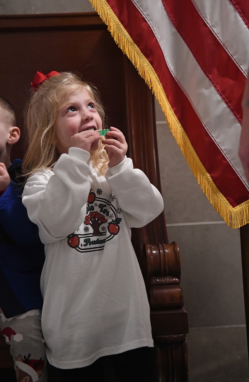 Eileen Wisniowicz/News Tribune photo: 
Brynley Forsythe, 4, chomps on a cookie after singing Christmas carols during Gov. Mike Parson's Christmas Tree Dedication Ceremony on Wednesday, Dec. 7, 2022, at the Missouri State Capitol. Forsythe is a part of Apple Tree Academy.