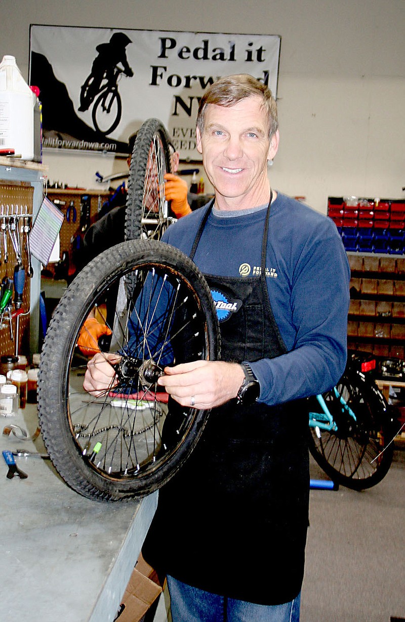 Chris Stockman volunteers at Pedal It Forward, repairing bikes that are given to people in need. At Christmas time the organization focuses on children’s bikes and sends hundreds out with the help of partners.

(Special to NWA Democrat-Gazette/Lynn Atkins)