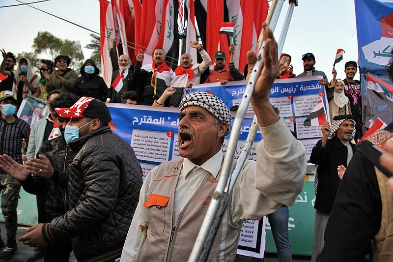 FILE - Protesters chant slogans against Iran in Tahrir Square during anti-government demonstrations in Baghdad, Iraq, Dec. 26, 2019. Hayder al-Zaidi, an Iraqi activist, was sentenced Monday, Dec. 5, 2022, to three years in prison over alleged criticism of state-sanctioned militias, spurring criticism from human right monitors and local activists. Al-Zaidi, who was active in popular anti-government protests that began in October 2019, was sentenced in a criminal court in Baghdad over comments on Twitter that he maintains he did not write. (AP Photo/Khalid Mohammed, File)