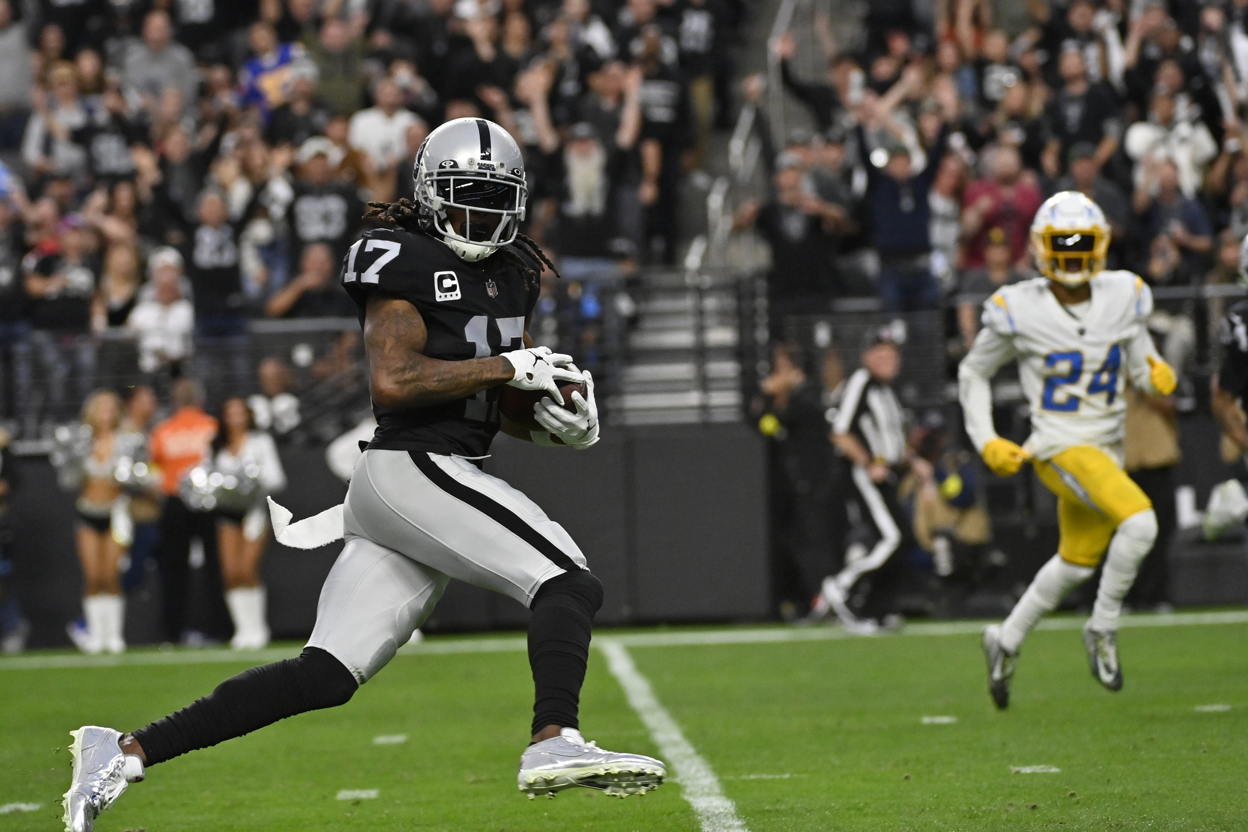 Las Vegas Raiders running back Josh Jacobs (28) carries against Los Angeles  Chargers linebacker Drue Tranquill (49) during the first half of an NFL  football game, Sunday, Dec. 4, 2022, in Las