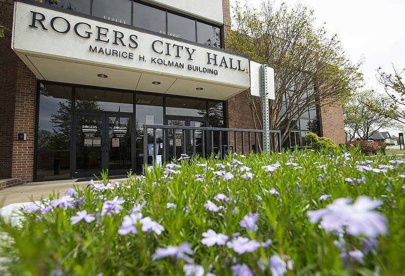 Flowers bloom May 1, 2020, at the entrance to Rogers City Hall. 
(File Photo/NWA Democrat-Gazette)