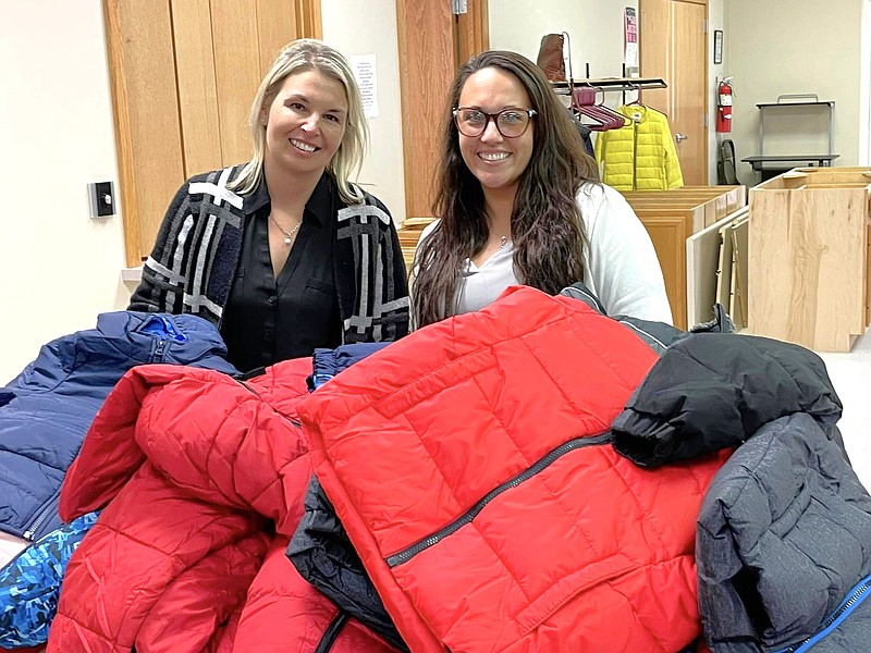 Amanda Gowin (left) and Andrea Bedrosian sort coats for Fulton Rotary’s Coats for Callaway Kids project.