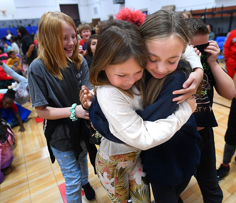 Lumen Dietrich (right), a fourth-grader at Washington Elementary School, celebrates Friday, Dec. 9, 2022, her second-place finish with friend Maggie Stone at the conclusion of the school’s spelling bee in the school’s gymnasium in Fayetteville. The winner of each school’s spelling bee in the county will compete in the Washington County Spelling Bee after the first of the year. Visit nwaonline.com/photo for today's photo gallery. 
(NWA Democrat-Gazette/Andy Shupe)