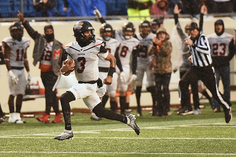 Malvern quarterback Cedric Simmons looks behind him as he runs for a touchdown during the Class 4A state football championship against Harding Academy Saturday at War Memorial Stadium in Little Rock. - Photo by Staci Vandagriff of The Associated Press